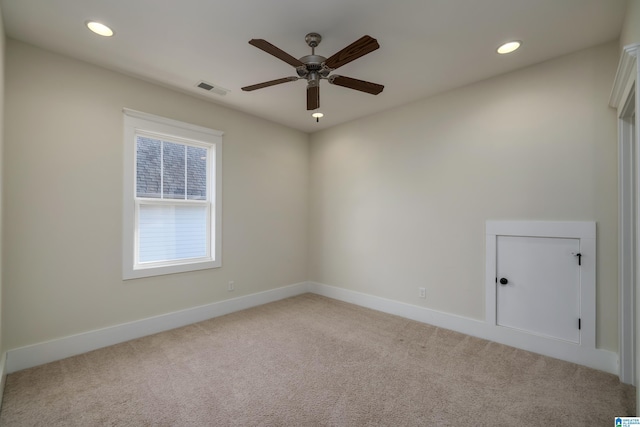 empty room with recessed lighting, visible vents, light carpet, and baseboards