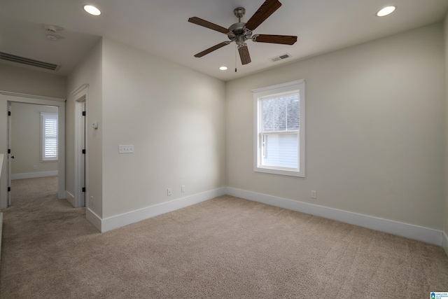 empty room with recessed lighting, visible vents, and light colored carpet