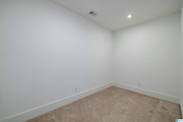 spare room featuring recessed lighting, baseboards, visible vents, and light colored carpet