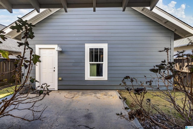 back of property with a patio area and fence