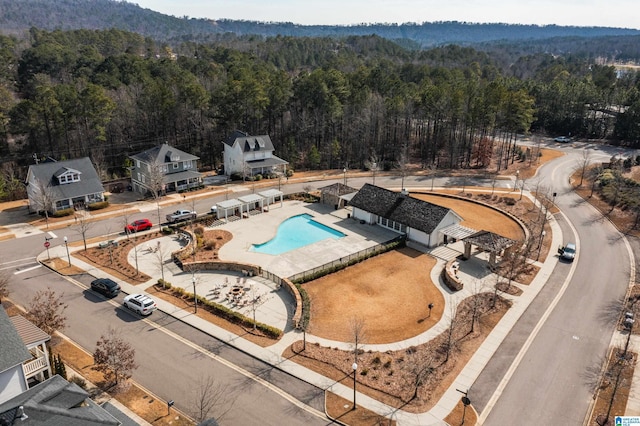 bird's eye view with a wooded view