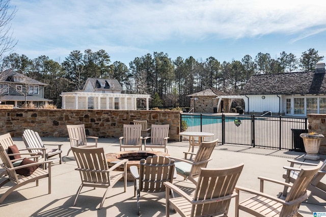 view of patio / terrace featuring an outdoor fire pit, a fenced in pool, and a pergola