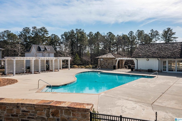 community pool with a patio area, a pergola, and french doors