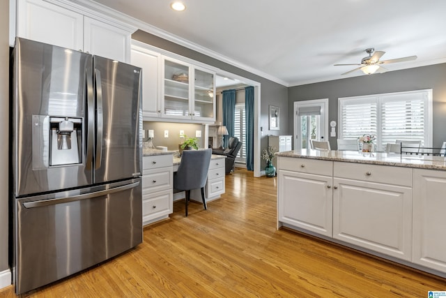 kitchen with white cabinetry, stainless steel fridge with ice dispenser, light wood finished floors, glass insert cabinets, and crown molding