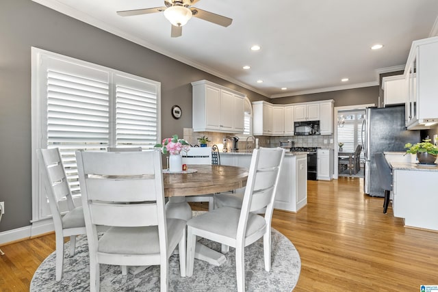 dining area with ornamental molding, recessed lighting, a ceiling fan, and light wood-style floors