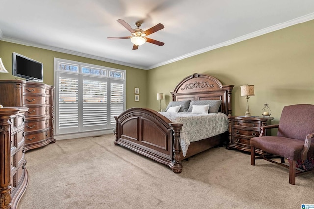 bedroom with light carpet, ornamental molding, and a ceiling fan