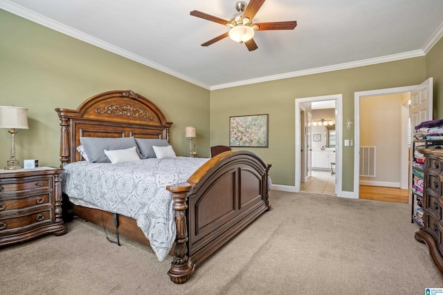 carpeted bedroom featuring baseboards, ornamental molding, visible vents, and a ceiling fan