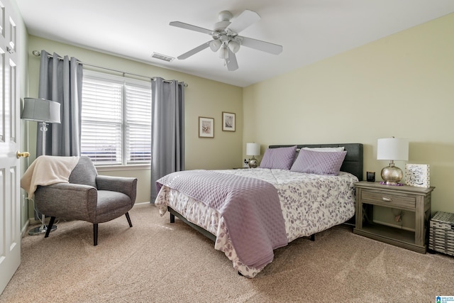 bedroom featuring ceiling fan, visible vents, and light colored carpet