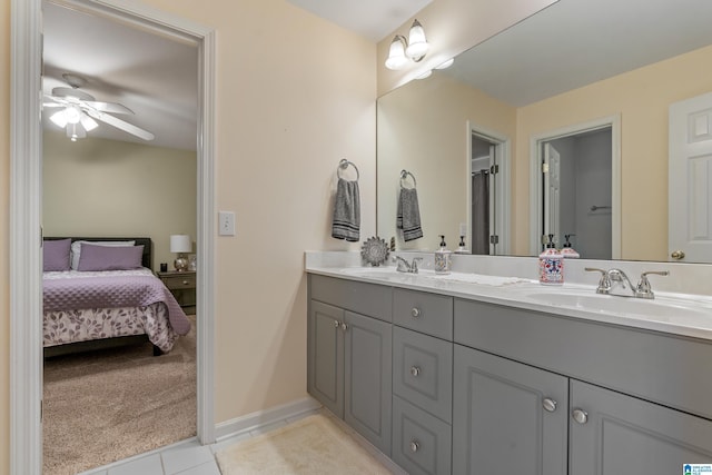 ensuite bathroom featuring double vanity, ensuite bath, a sink, and tile patterned floors