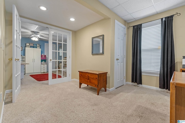 interior space featuring carpet floors, french doors, and baseboards