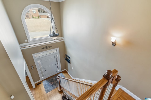 entryway with visible vents, baseboards, and wood finished floors