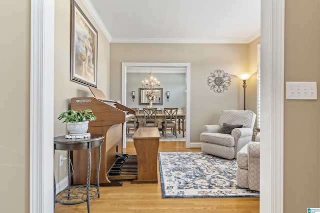 living area with ornamental molding, baseboards, and wood finished floors