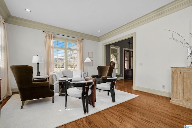 sitting room featuring recessed lighting, crown molding, baseboards, and wood finished floors