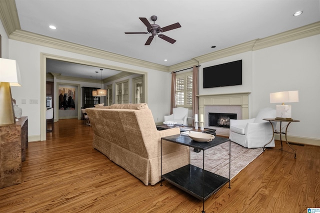 living room with a fireplace, recessed lighting, ceiling fan, wood finished floors, and baseboards