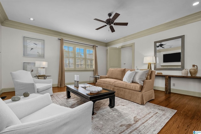 living area with crown molding, baseboards, and wood finished floors