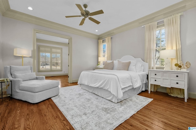 bedroom with ceiling fan, recessed lighting, wood finished floors, baseboards, and crown molding