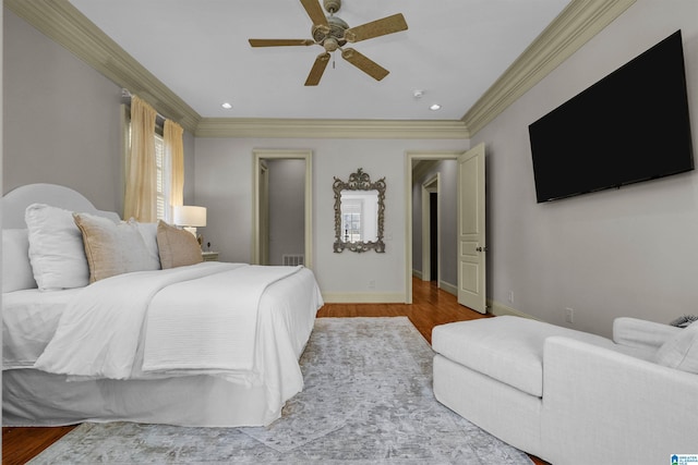 bedroom featuring recessed lighting, baseboards, wood finished floors, and ornamental molding