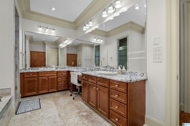 full bath featuring double vanity, a sink, and crown molding