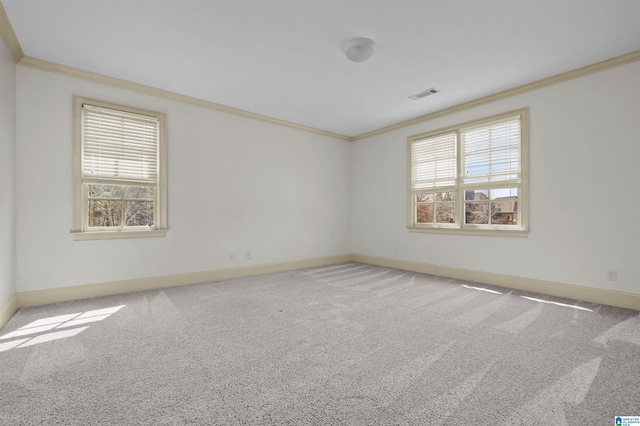 carpeted empty room with ornamental molding, visible vents, and baseboards