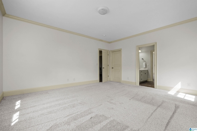 unfurnished bedroom with baseboards, carpet, ensuite bath, and crown molding