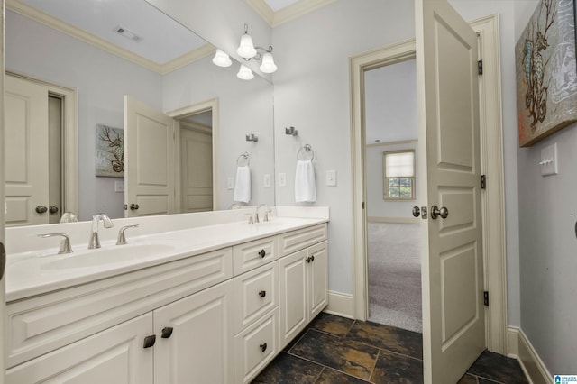 bathroom featuring baseboards, visible vents, a sink, and ornamental molding