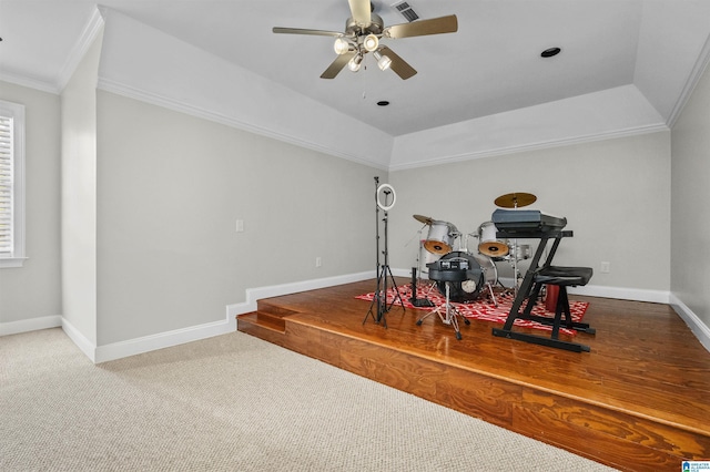 playroom with a tray ceiling, visible vents, crown molding, and baseboards