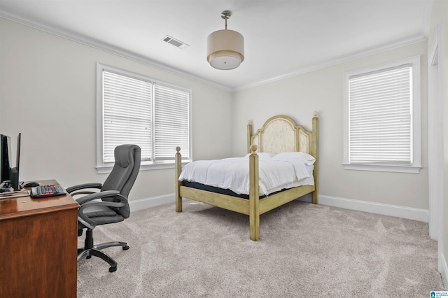 carpeted bedroom featuring ornamental molding, visible vents, and baseboards