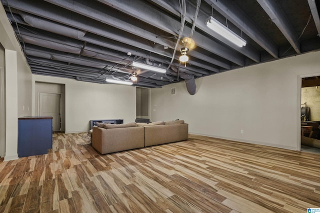 living room with baseboards and wood finished floors