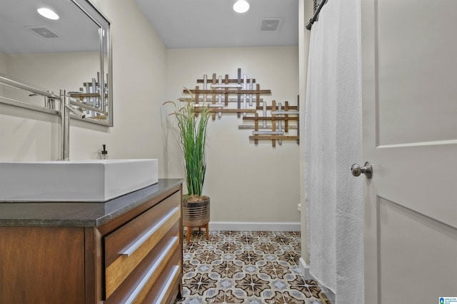 bathroom with recessed lighting, vanity, visible vents, and baseboards