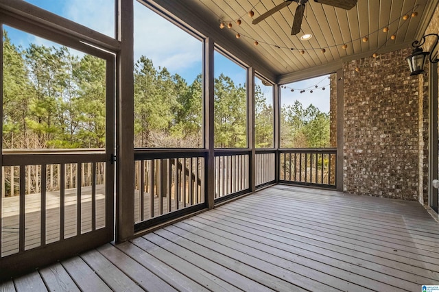 unfurnished sunroom with ceiling fan