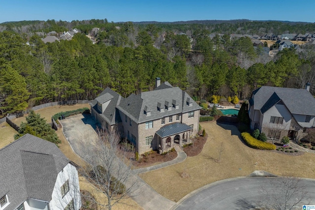 birds eye view of property with a view of trees