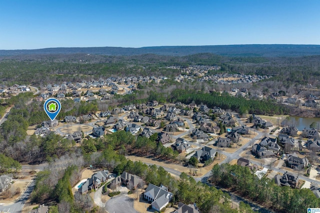 drone / aerial view featuring a residential view and a wooded view