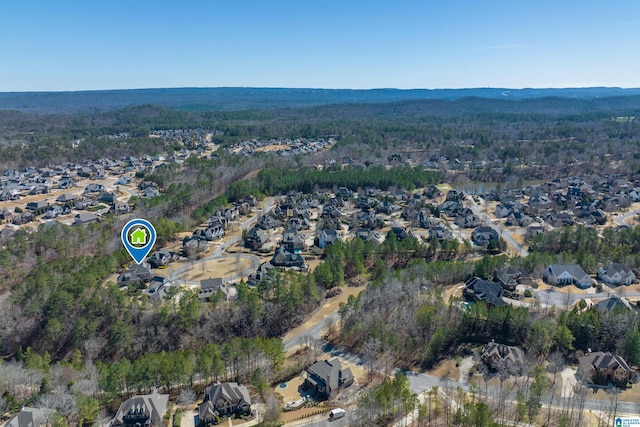 drone / aerial view with a residential view and a view of trees