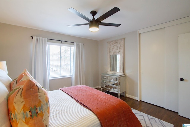 bedroom with dark wood-style flooring, a closet, and a ceiling fan