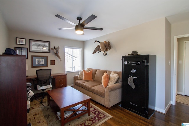 living area featuring ceiling fan, baseboards, and wood finished floors