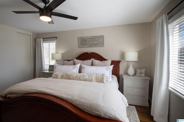 bedroom with dark wood-type flooring and ceiling fan