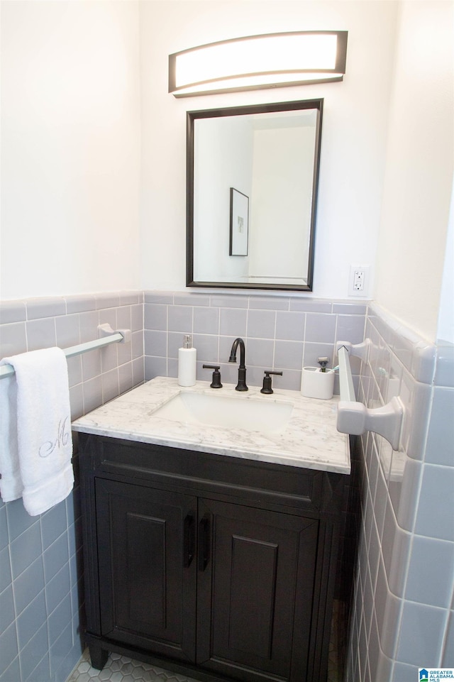 bathroom with wainscoting, tile walls, and vanity