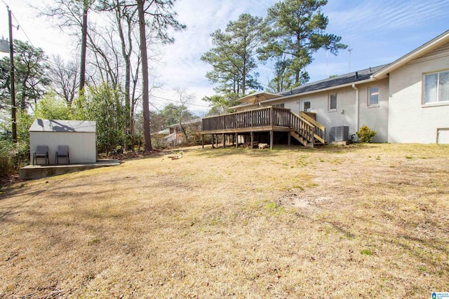 view of yard featuring cooling unit, an outdoor structure, stairway, a wooden deck, and a shed