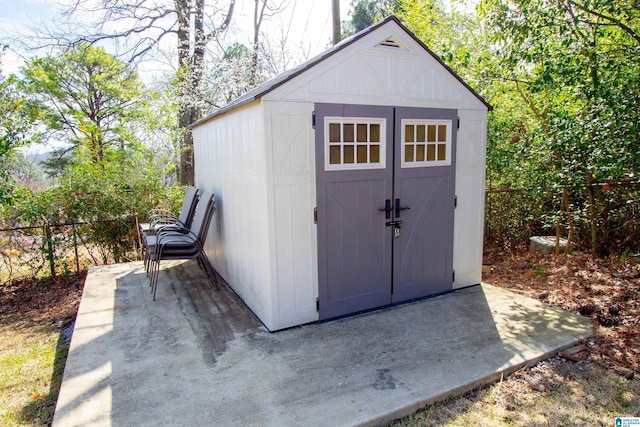 view of shed with fence