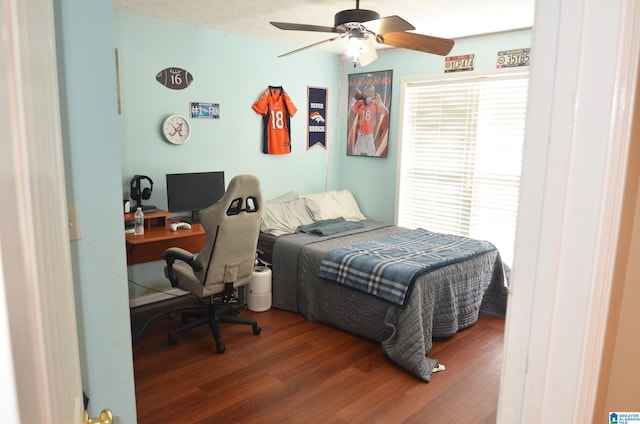 bedroom with a ceiling fan and wood finished floors