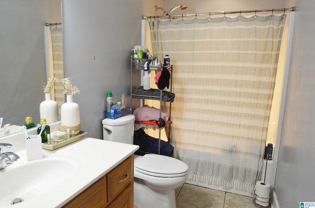 bathroom featuring a shower with shower curtain, vanity, toilet, and tile patterned floors