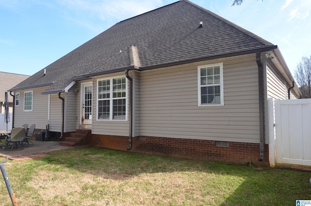 back of property featuring entry steps, a patio, fence, a yard, and crawl space