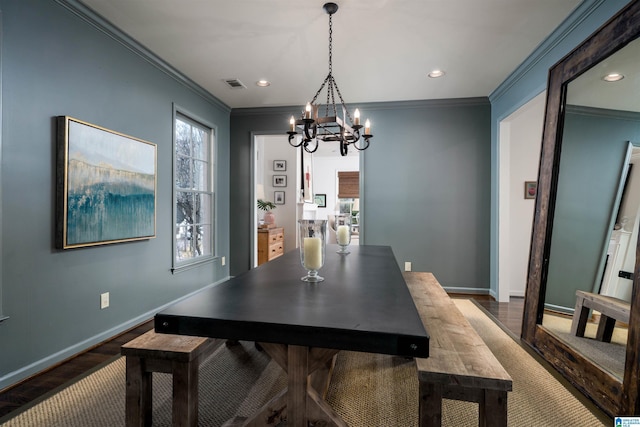 dining room featuring visible vents, crown molding, and baseboards