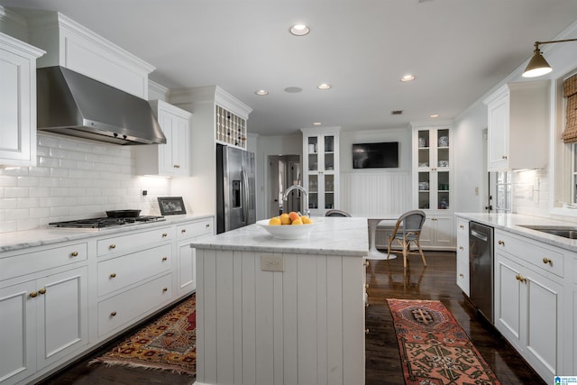 kitchen with white cabinets, wall chimney exhaust hood, dark wood-style floors, and appliances with stainless steel finishes