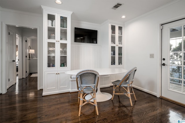 dining area featuring visible vents, breakfast area, dark wood-type flooring, and ornamental molding