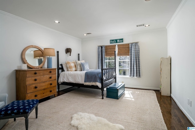 bedroom featuring visible vents, ornamental molding, wood finished floors, recessed lighting, and baseboards