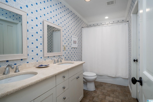 bathroom with visible vents, toilet, crown molding, and a sink