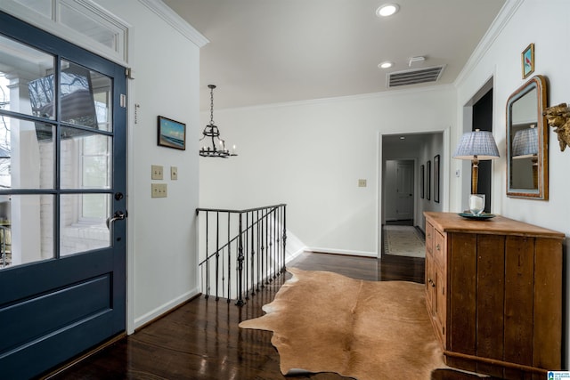 foyer entrance featuring crown molding, dark wood-style floors, visible vents, and baseboards