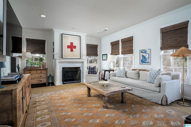 living room with recessed lighting, a healthy amount of sunlight, a fireplace, and ornamental molding