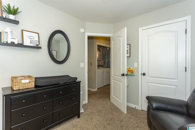 interior space with light carpet, separate washer and dryer, and baseboards